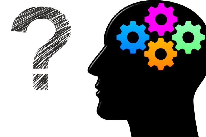 Silhouette of a human head with colourful gears and a question mark representing the battle of the mind and internal thoughts